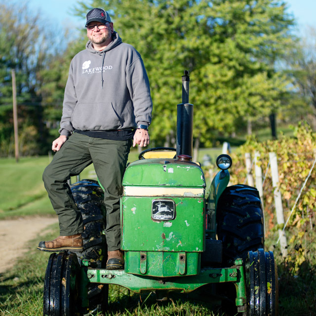 Tracy Gumtow standing on tractor