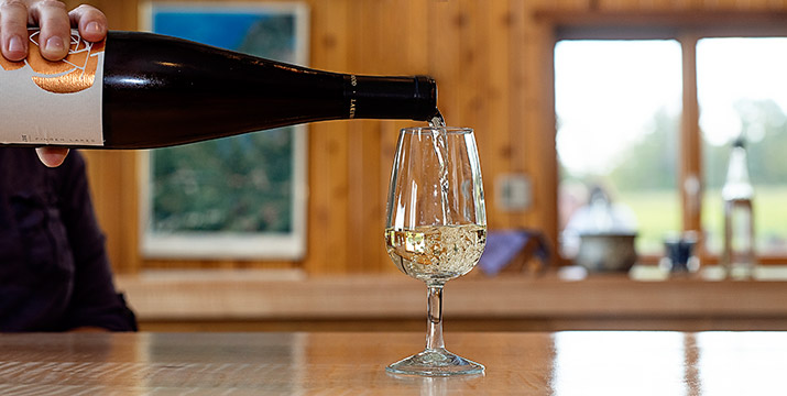 Poring glass of white wine